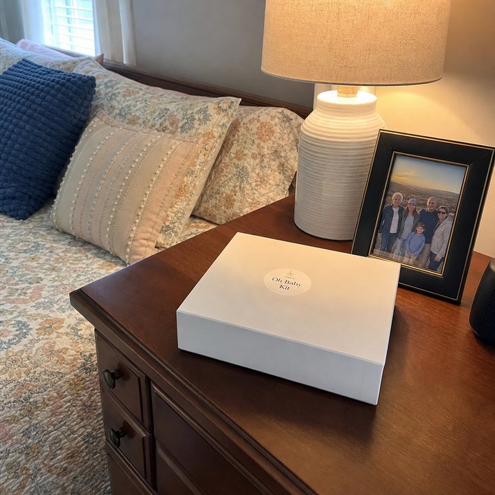Oh Baby Kit box on the dresser of a cozy guest bedroom.